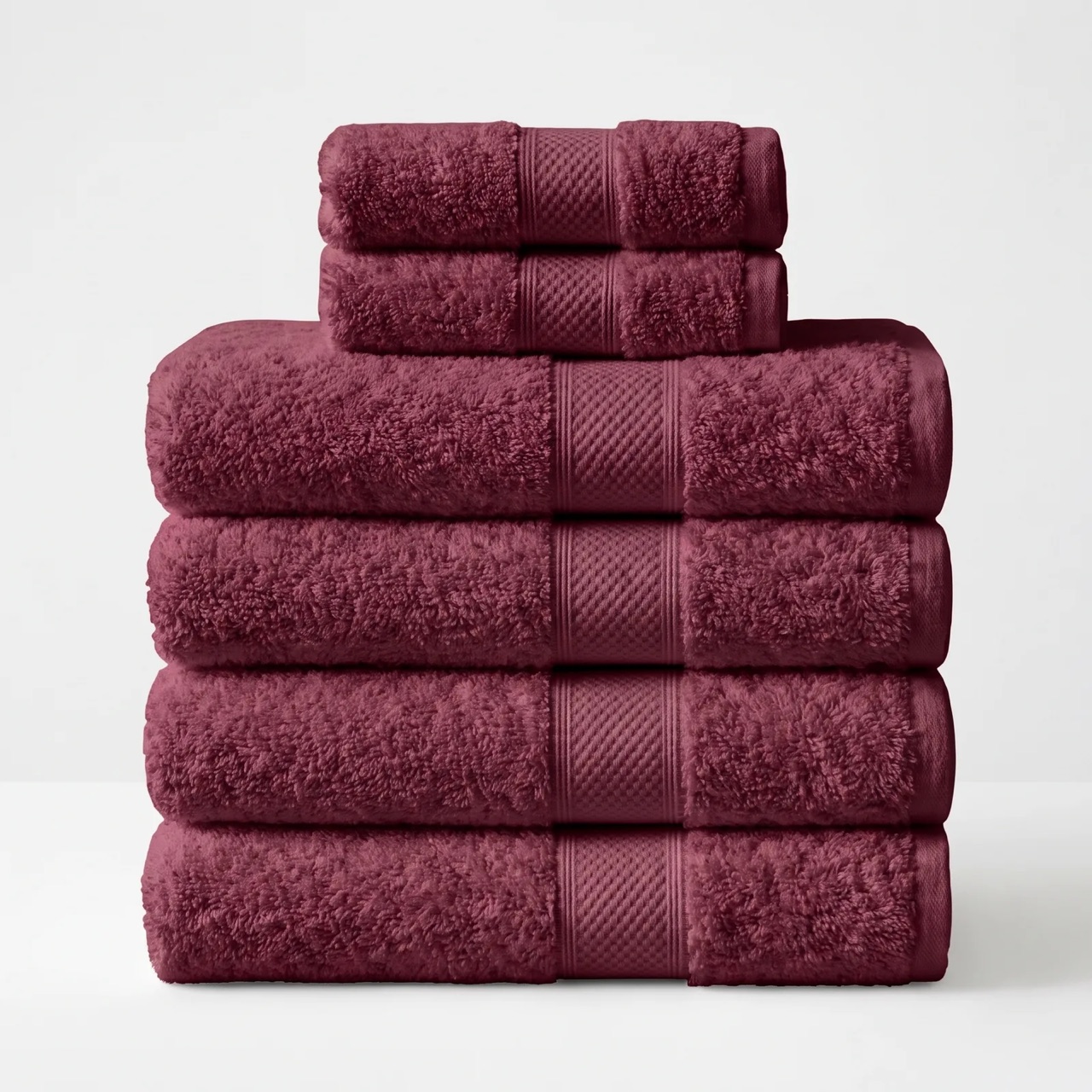 Kemet Cotton Christmas bath bundle in Maroon, four deep garnet red Egyptian cotton bath towels and two hand towels folded in a stack