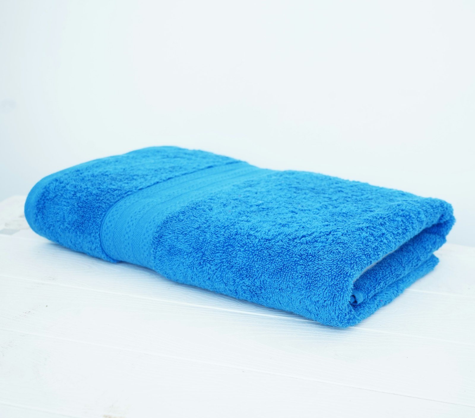Rolled spa towels stacked for a commercial spa and wellness program