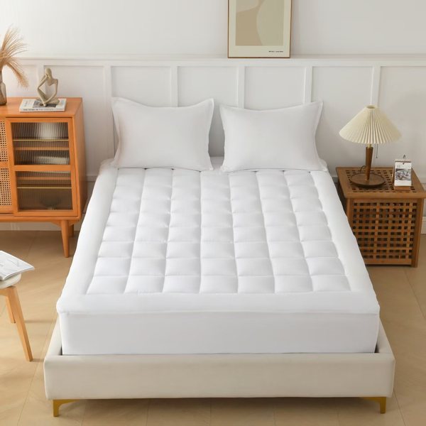 The Pillow Home CloudLift cooling mattress topper fitted on a bed