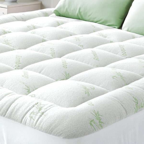 OrthoBed mattress topper with bamboo-print cover on a bed